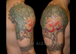 Right arm tattoo in color ink of a green celtic knot tree with orange ohm symbol by Natan Alexander